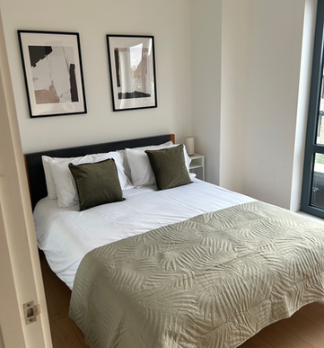 Modern king-size bed in Cocoon Apartment