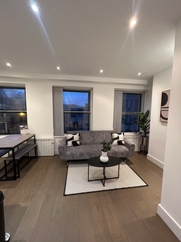 Modern apartment living room with sofa and city view