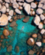 Clear kayak floating on glassy lake surface with distant mountains in background