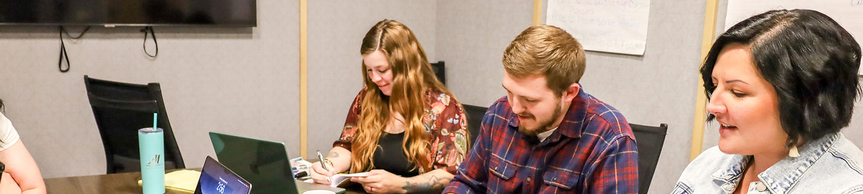 marketing team sitting around a table.jpg
