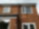 Brick house facade with windows,and gutter pipes