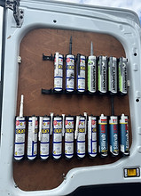 A wooden panel inside a van displays various tubes