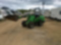 A green mini excavator in a parking area