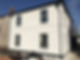 External view of a rendered house with a guttering system