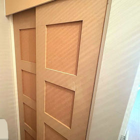 Close-up of a wooden sliding door featuring a simple panelled design