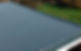A flat, freshly coated grey roof surface with a smooth finish