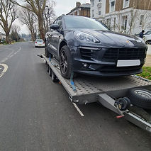 A black car on a car hauler