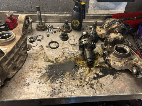 A workbench with various tools and parts