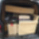 A removal van filled with a mattress, suitcases, and assorted furniture