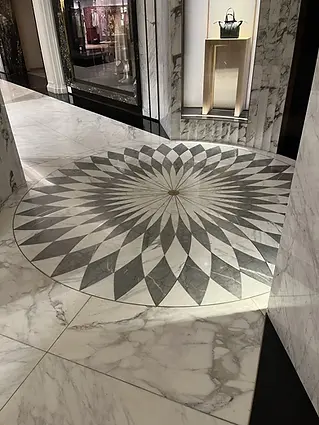 Intricate circular marble floor inlay restored to a high-gloss finish