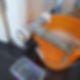 A leaking pipe with sealant over it, drains into an orange bucket