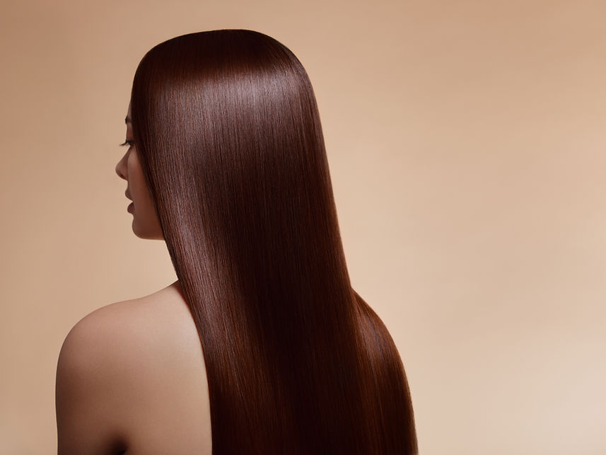 A person with smooth, straight brown hair shown from behind
