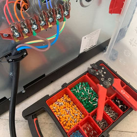 An electrical wiring panel with colourful cables connected
