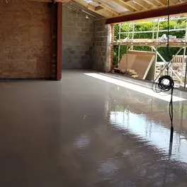 A spacious floor of a hall being insulated with liquid screed