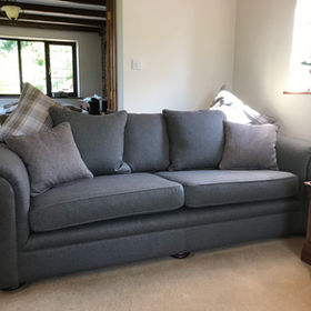 A grey sofa with cushions