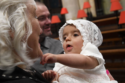 An old lady holding a baby