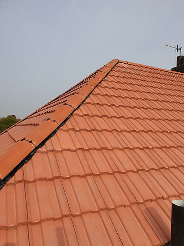 Sloped roof covered with orange terracotta tiles
