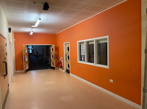 A hallway with newly painted orange walls