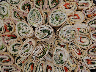 Close-up of assorted tortilla wraps filled with vegetables and meats