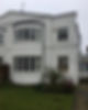 A newly rendered house corner with a curved bay window