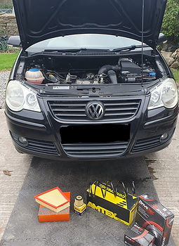 Front view of a black car with its hood open