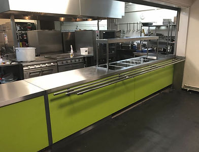 A commercial kitchen with lime green cabinets