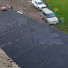 Flat roof of a building with visible water patches