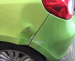 The back side view of a green vehicle