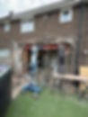 A professional renovating a home using scaffolding