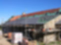 House under construction with half-finished roof and scaffolding