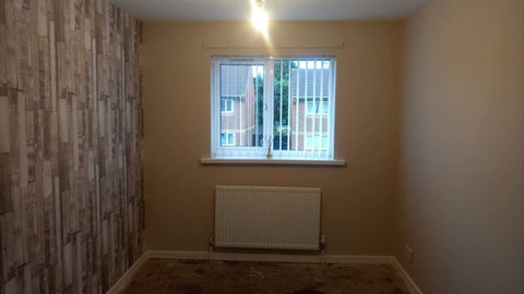 After image of newly painted and wallpaper wall