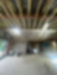 An unfinished room with exposed wooden rafters