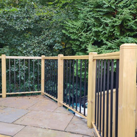 A wooden fence surrounding a paved area
