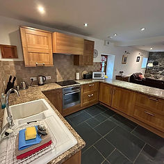 Modern kitchen with wooden cabinets, granite countertops, and stainless steel appliances