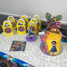 A vibrant birthday scene featuring a colorful cake, goody bags