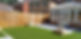 Back garden with a conservatory, artificial grass, wooden fence, and paving slabs