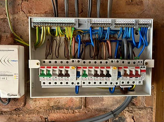 A wall-mounted electrical panel with neatly organized wires and circuit breakers