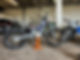 A trial motorcycle on an orange stand inside a workshop