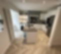 Kitchen with wooden flooring, a central island, and ceiling lights for illumination