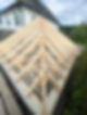 A close-up view of a wooden roof structure under construction