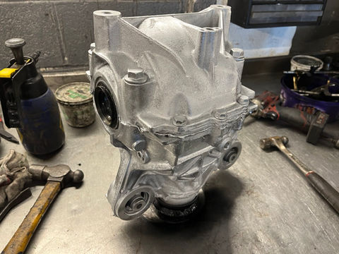 A silver car engine on a work bench