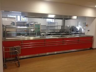 A commercial kitchen with red cabinets