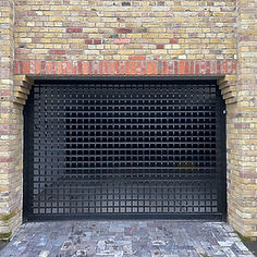 A black metal security gate with a grid pattern