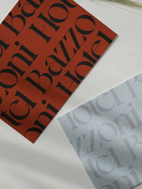 Two elegant flyers printed on uncoated paper featuring the Hotel Bazzoni branding with bold logo and refined colour palette