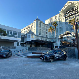 two vehicles parked outside a hotel