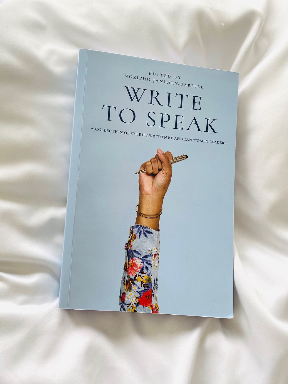A book with hand on the cover