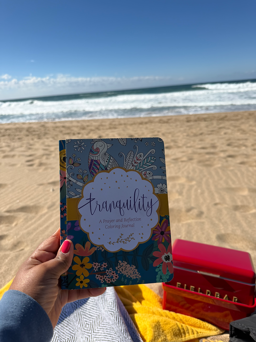 A woman's hand holding a tranquility journal
