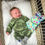 Thumbnail: Smiling baby with the Friendly Monster Weighted Plush