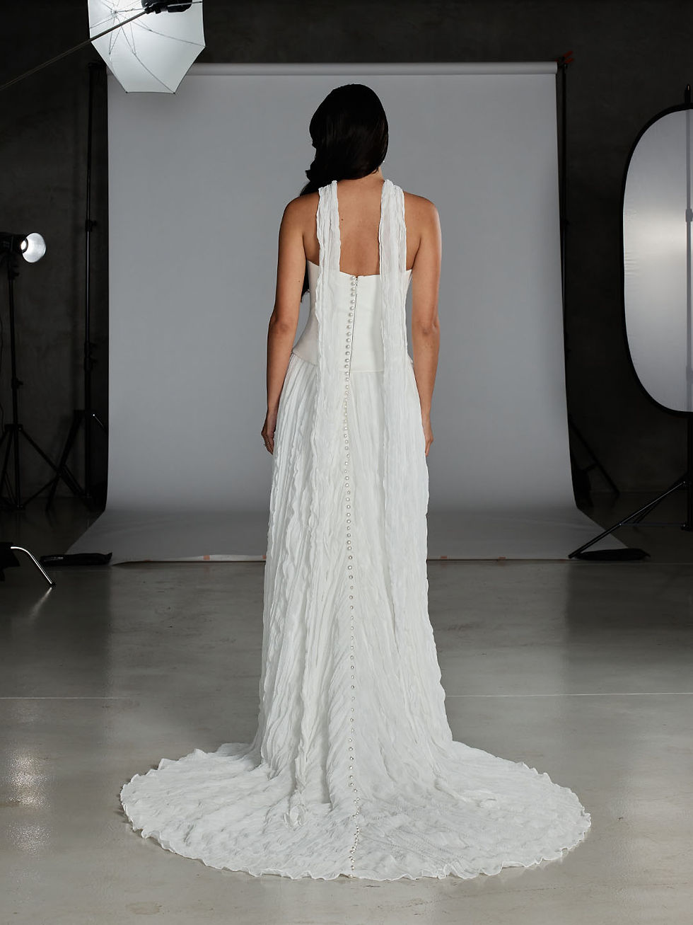 Thumbnail: Back view of Bette wedding dress by Evie Young full length with neck scarf