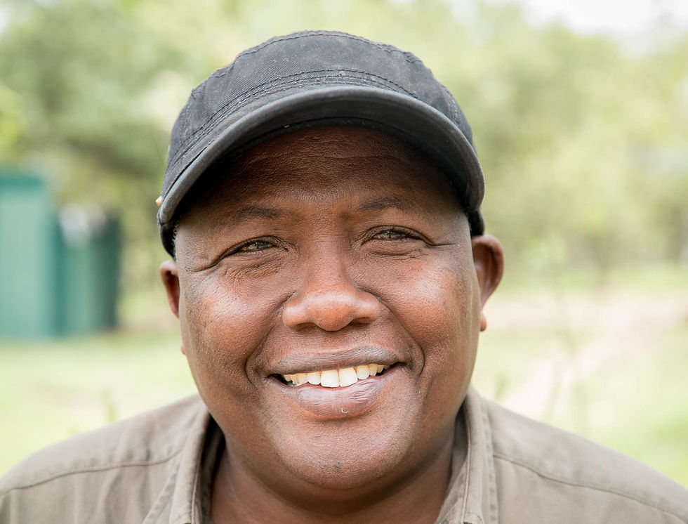 Meitamei Maasai Elder Dopoi Center Cofounder smiling wearing cap at Dopoi Center Maasai Mara